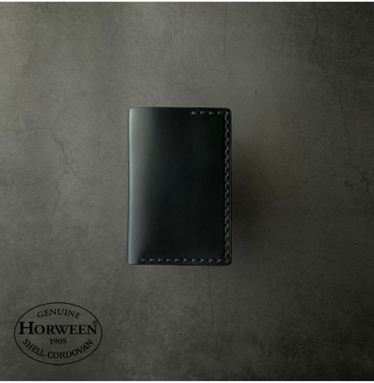 Black leather wallet on a textured gray background with Horween Shell Cordovan logo.