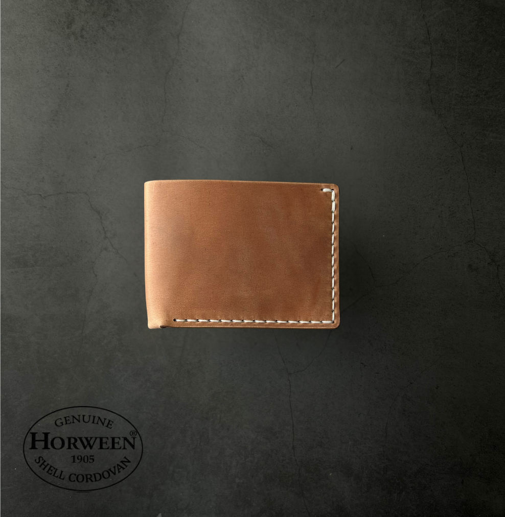 Brown leather wallet on a dark gray background with Horween logo.