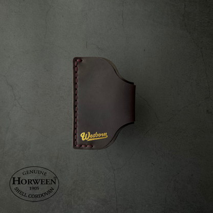 Brown leather wallet with 'Westvogt' branding on a dark gray background, featuring Horween Shell Cordovan logo.